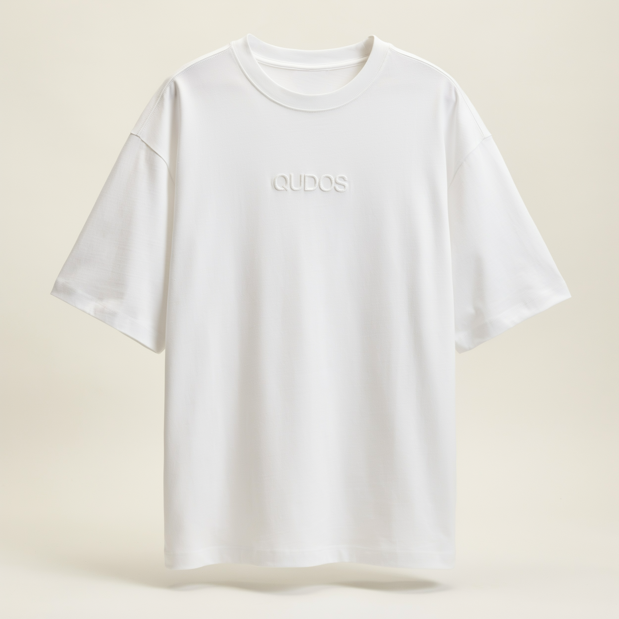 Qudos white t-shirt displayed as a study in minimalist apparel construction and fabric drape